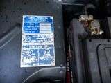 a close up of a car ' s engine with a sticker on it