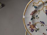 a plate with flowers on it sitting on a table