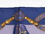 a close up of a blue and purple tie with a gold bow