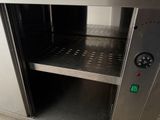 a stainless steel oven with a door open on the floor