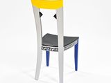 a black and white chair with a yellow seat on a white background