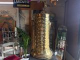 a large gold vase sitting on top of a table