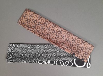 two ties that are laying next to each other on a table