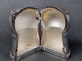 two pieces of silver that have been broken apart