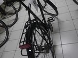 many bicycles that are sitting on the floor in a room