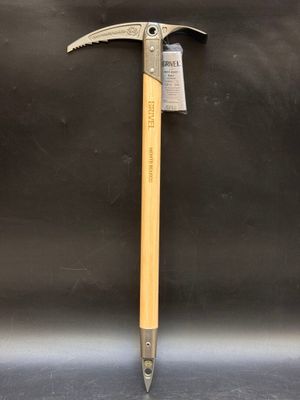 a hammer with a wooden handle sitting on top of a table
