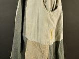 an old jacket with a patch on the front and a pocket on the back