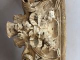 an image of a carved wall clock with a clock face on it