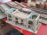 a small model of a building with a train coming out of it