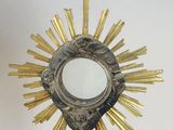 a silver and gold monsure with a cross on top of it