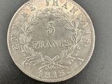 a silver five cents coin on a black surface