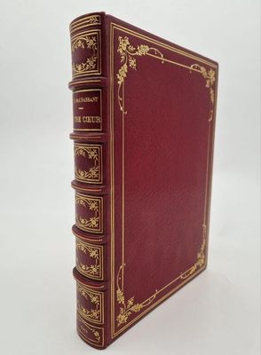 a red book sitting on top of a white surface