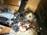 a pile of assorted items on the floor in a room
