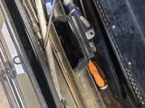 a black case with tools inside of it on a wooden floor