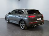 the rear end of a grey 2020 infiniti parked in a showroom