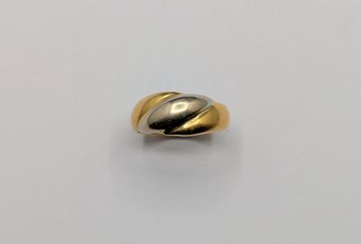 a close up of a gold and silver ring on a white surface