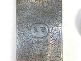 a silver cigarette case that has a picture of a cat on it