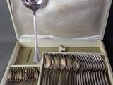 silverware in a case with a mirror and spoons in it
