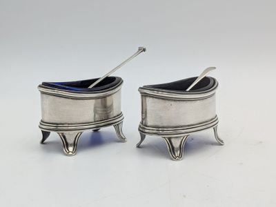 pair of silverplated salt and pepper shakers with spoons