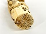 a close up of a wooden object on a white surface