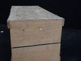 a small wooden box sitting on top of a black table