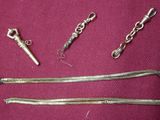 a silver chain and a pair of scissors on a purple cloth