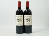 two bottles of wine sitting next to each other on a table