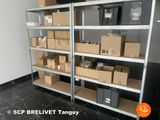 many boxes and boxes on the shelves in the room