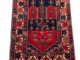 a red and black rug on a white background
