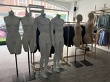 mannequins are lined up in a row in a clothing store