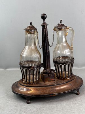 a silver plate with two glass vases on top of it