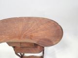 a wooden table with a fan on top of it