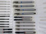 many different types of pens in a plastic case