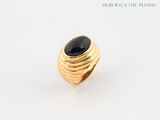 a close up of a gold ring with a black stone