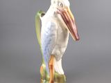 porcelain figurine of a white pelican with a long beak