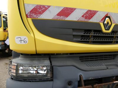 a yellow truck that is parked in a lot