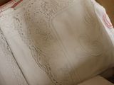 a close up of a bed with a pillow and a pillow case
