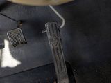 a close up of a pair of scissors on a piece of leather