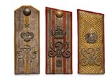 three military insignias are displayed on a white background