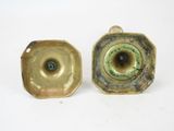 pair of antique brass candlesticks with green glaze eyes