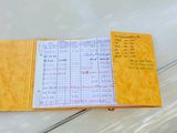 a yellow notebook with writing on it sitting on a table