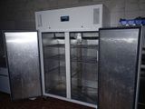 two refrigerators that are sitting in a kitchen