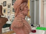 a bust of a man sitting on a table in a room