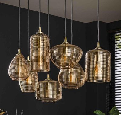 five lights hanging from the ceiling above a table
