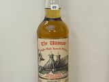 une vieille bouteille de whisky posée sur un comptoir