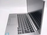 a silver laptop computer sitting on top of a white table
