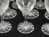 several clear wine glasses sitting on top of a black table