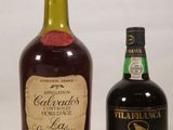two bottles of liquor sitting next to each other on a table
