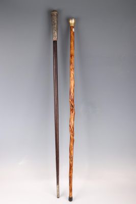 two wooden canes sitting next to each other on a white surface