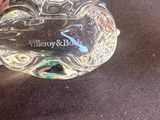 a glass object with a name on it sitting on a table